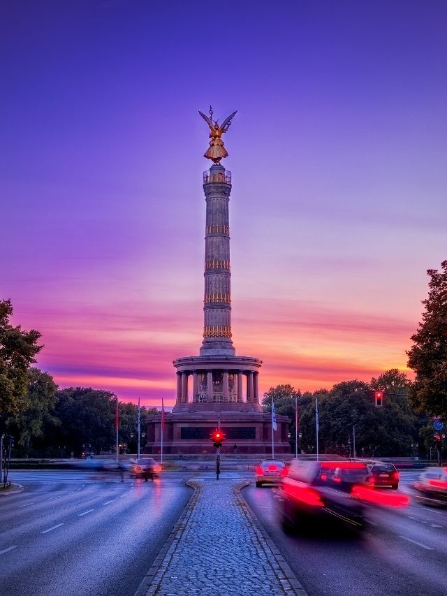 purple sunset with busy street and monument