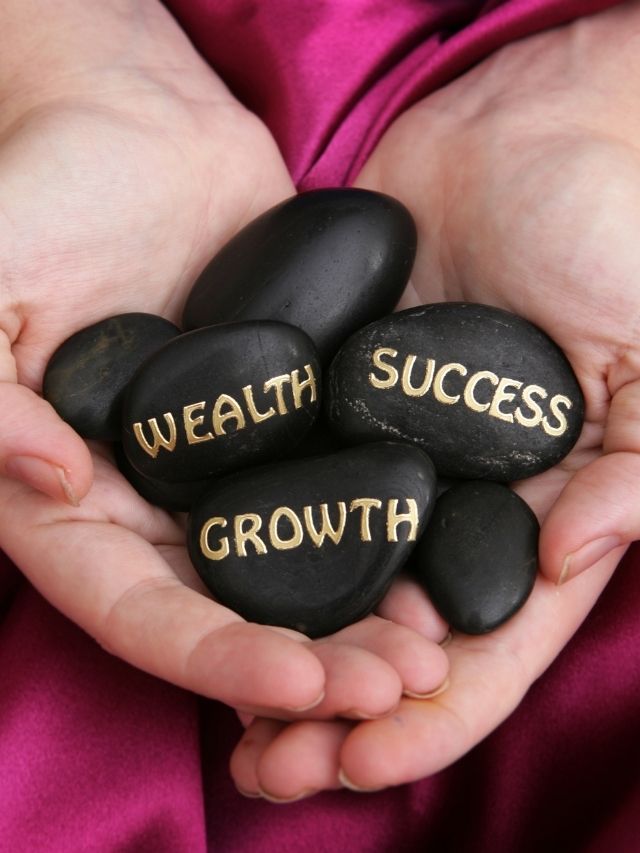 stones with wealth, success, and growth in gold letters