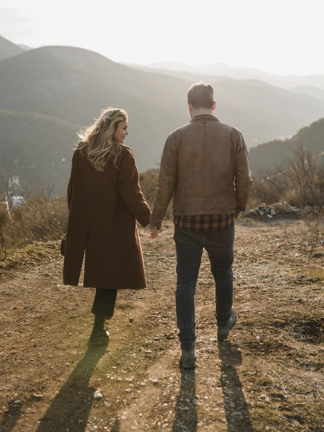 a couple walking together in the mountains