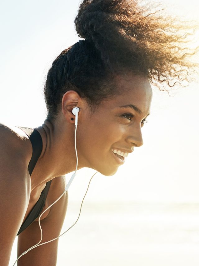 woman exercising with earbuds