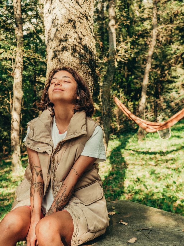 woman smiling while soaking up nature