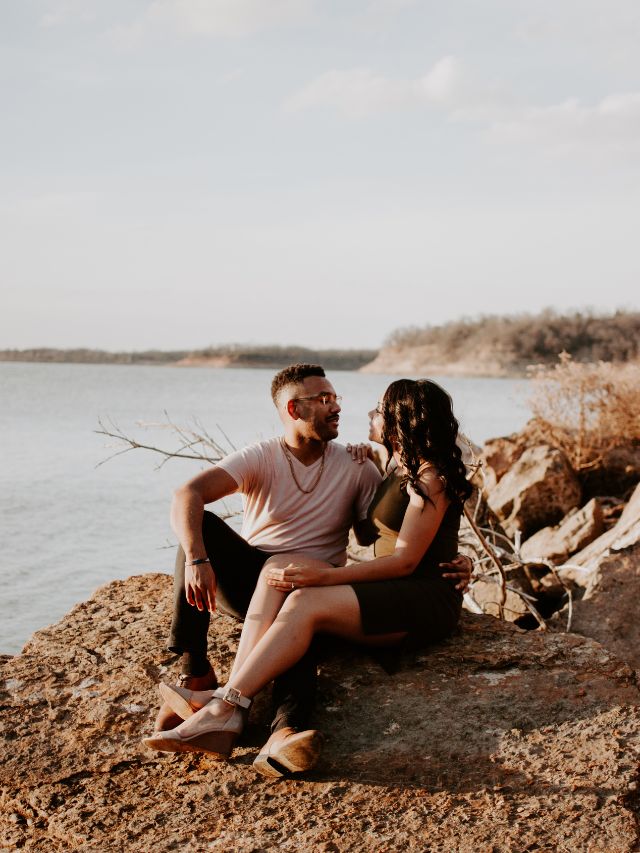 a couple sitting on rocks