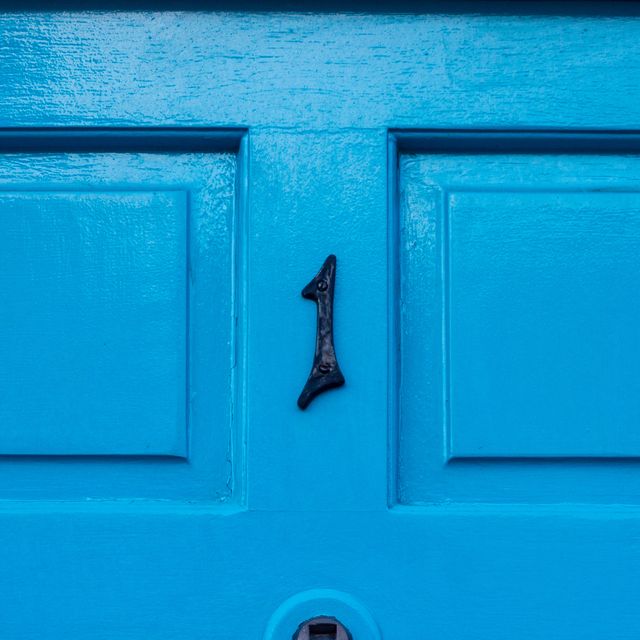 house number 1 on a blue wooden front door in london