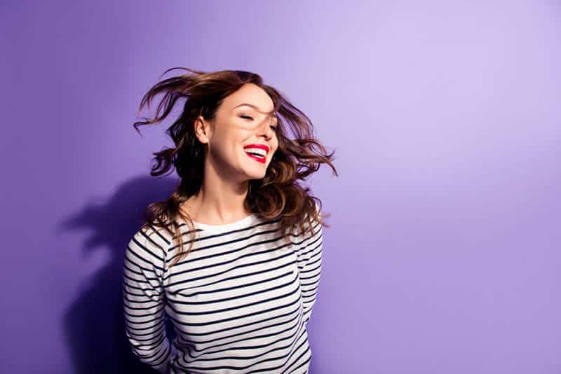smiling woman with purple background