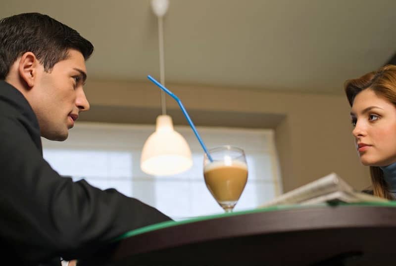 dating man and woman with a mocha drink in the table