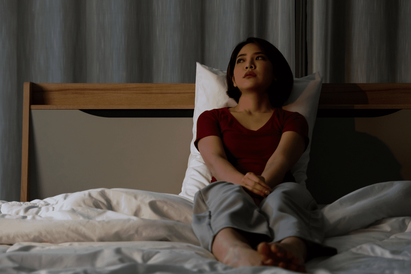 disappointed woman sitting on the bed