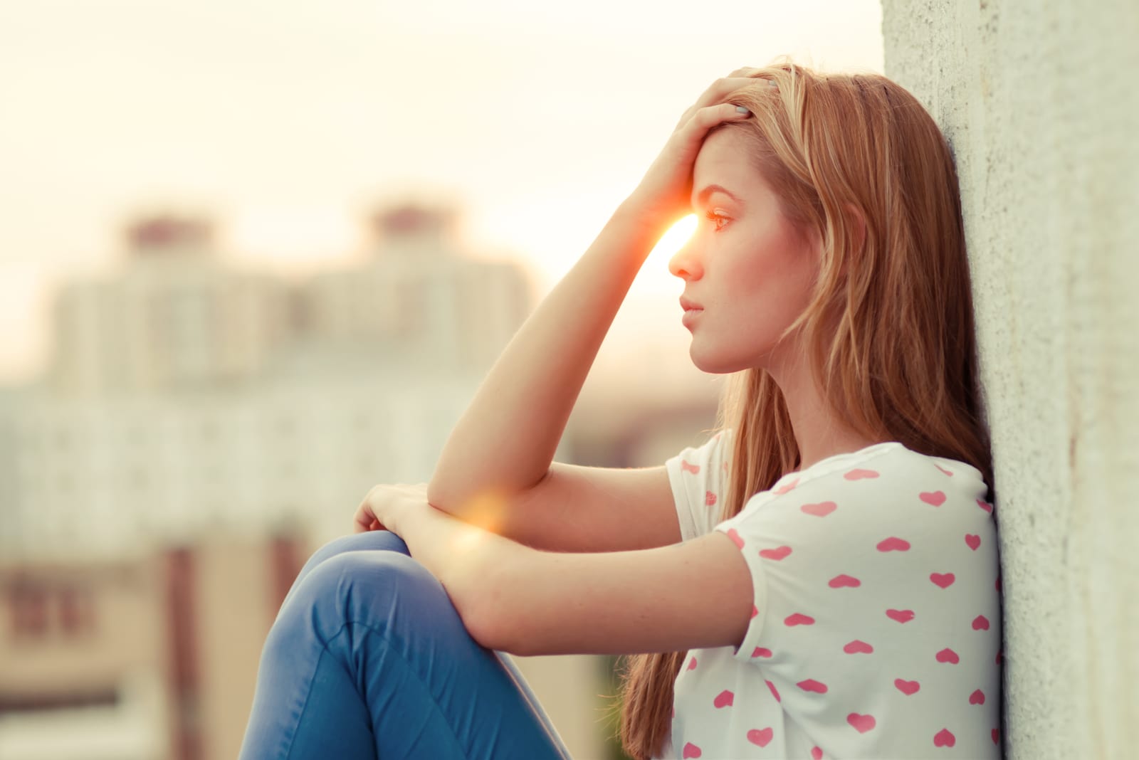 pretty worried woman sitting on the roof