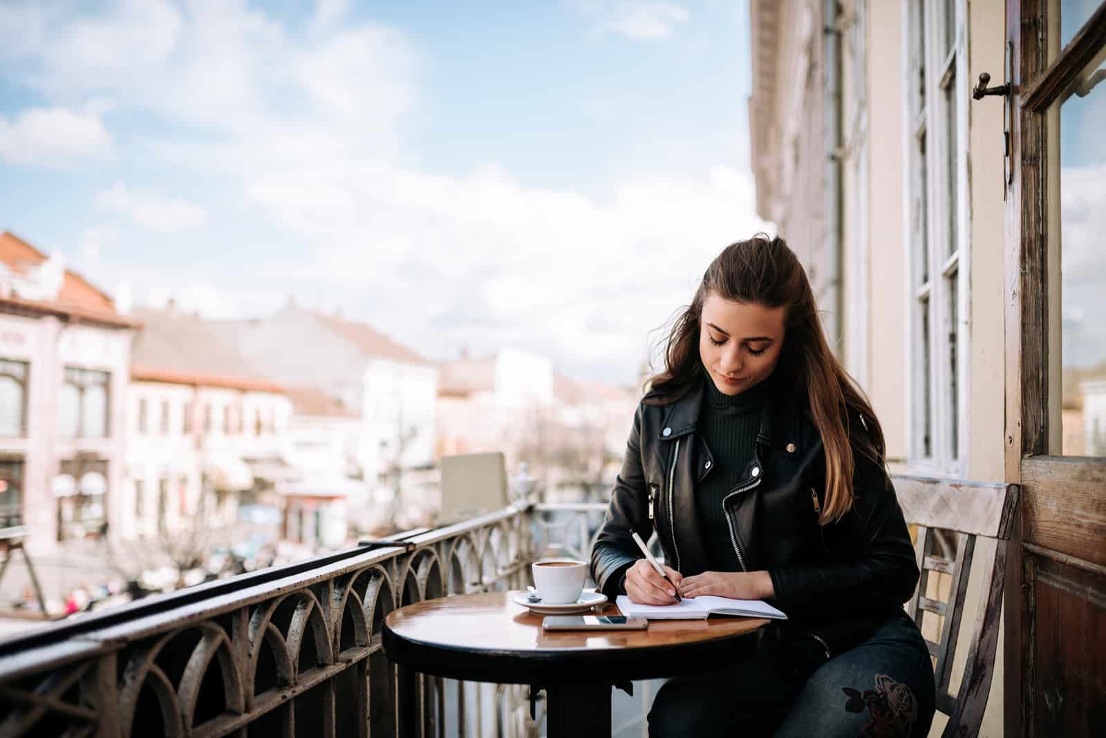 an imaginary woman is sitting in a cafe and writing something over coffee