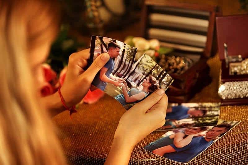 woman cutting picture of her ex boyfriend