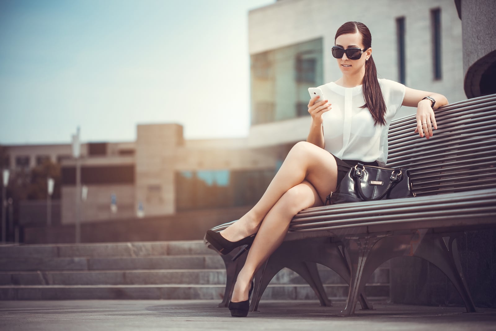 beautiful brunette woman sitting on the bench