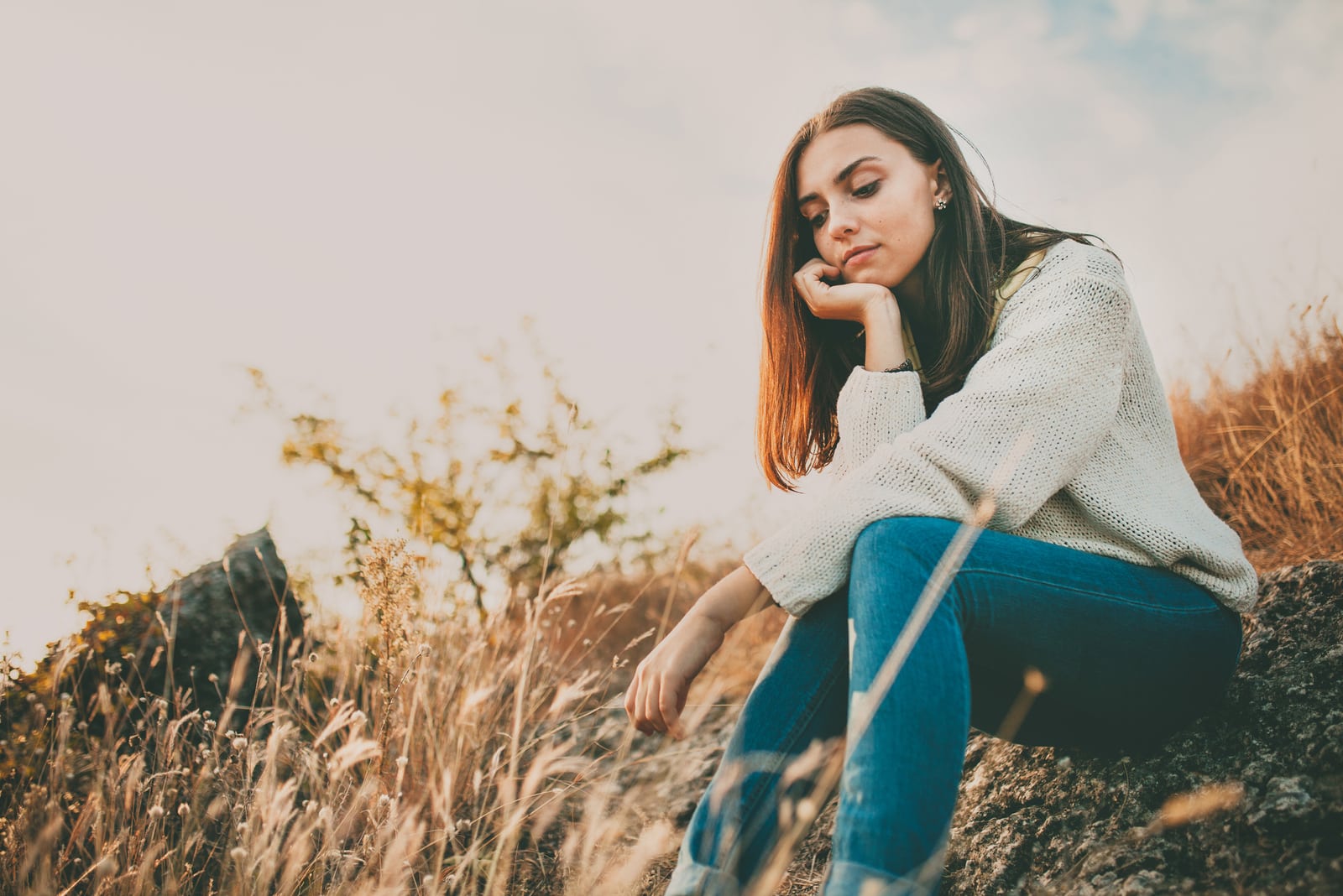 lonely woman sitting in nature